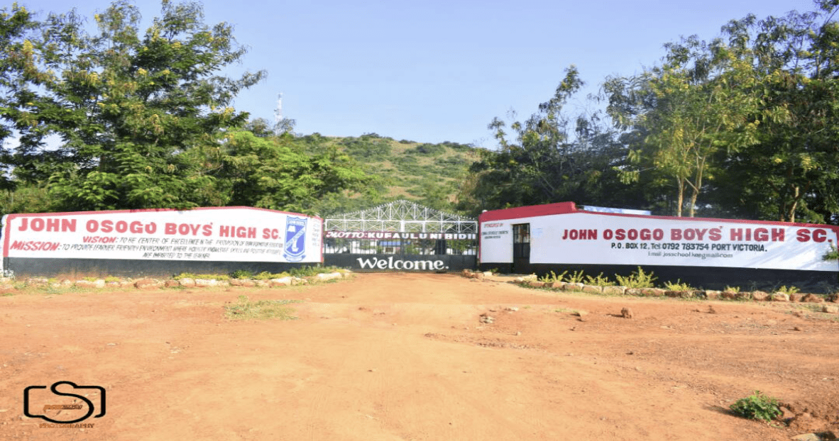 The entrance to a school with a sign in front of it.