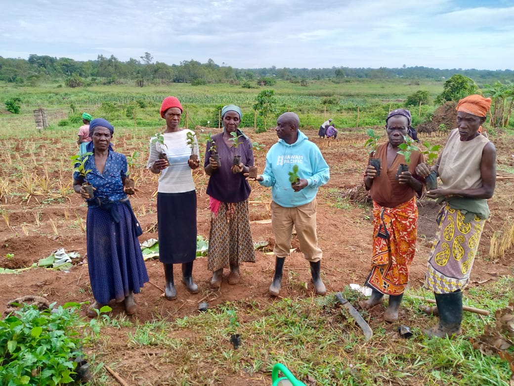 A group of people standing in front of a blackboard.