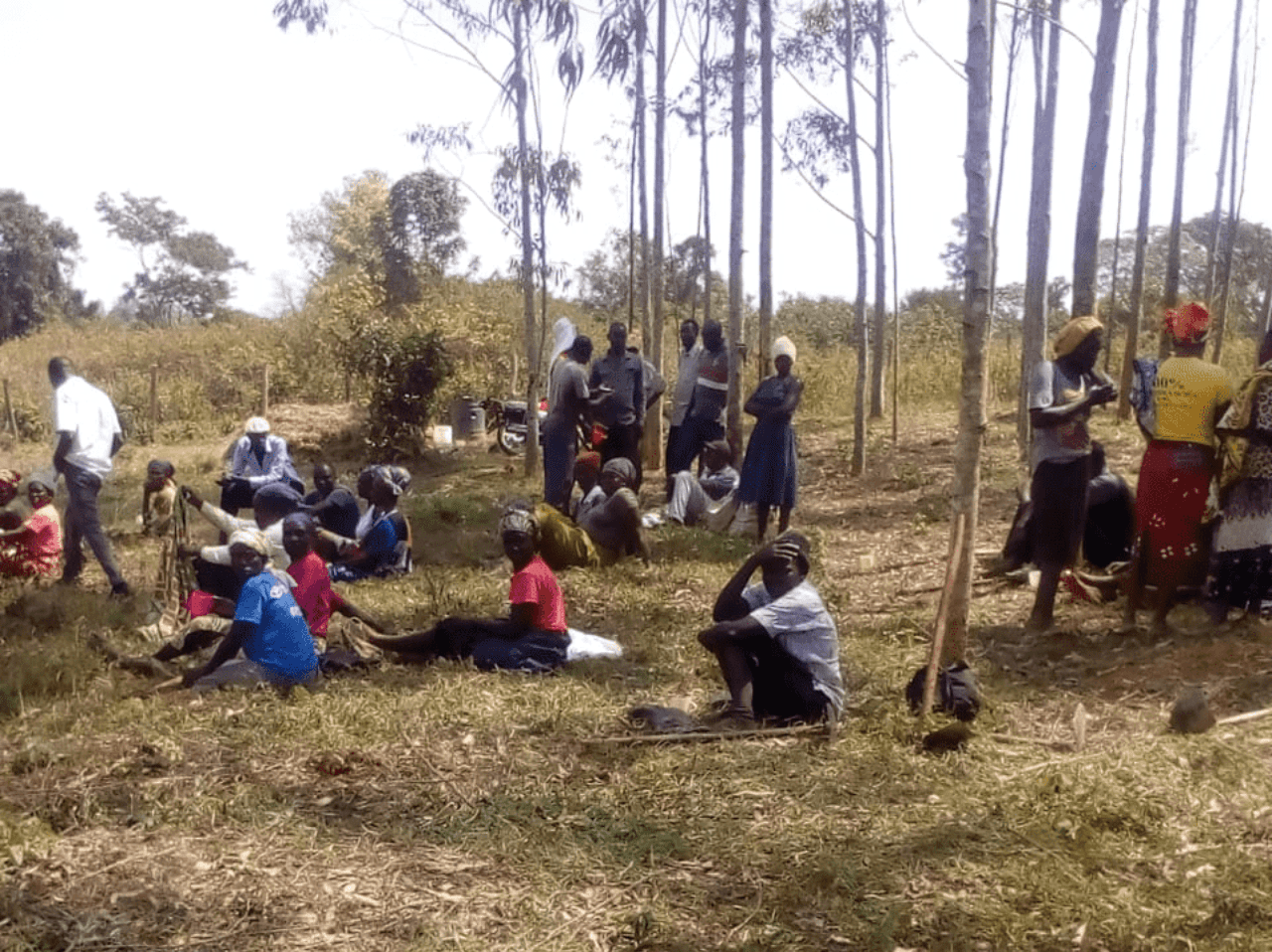 A group of people standing in front of a blackboard.