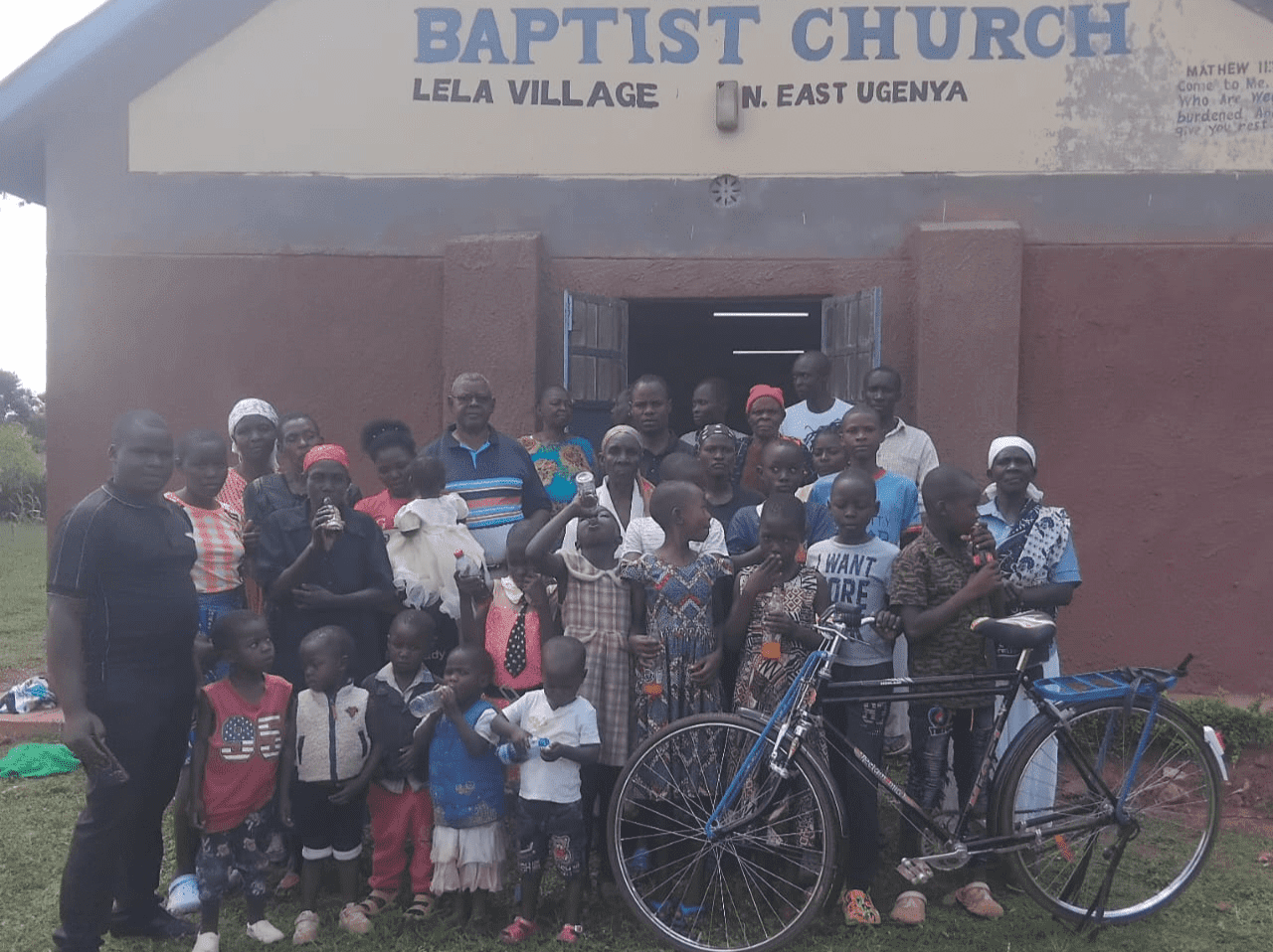 A group of people standing in front of a blackboard.